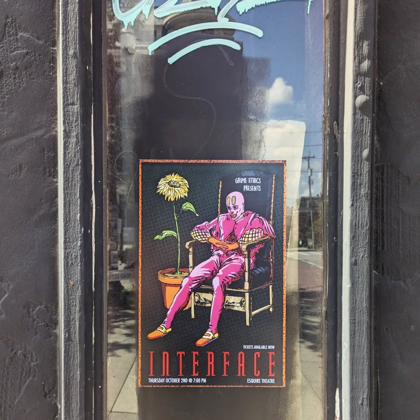 The Interface poster in a black door