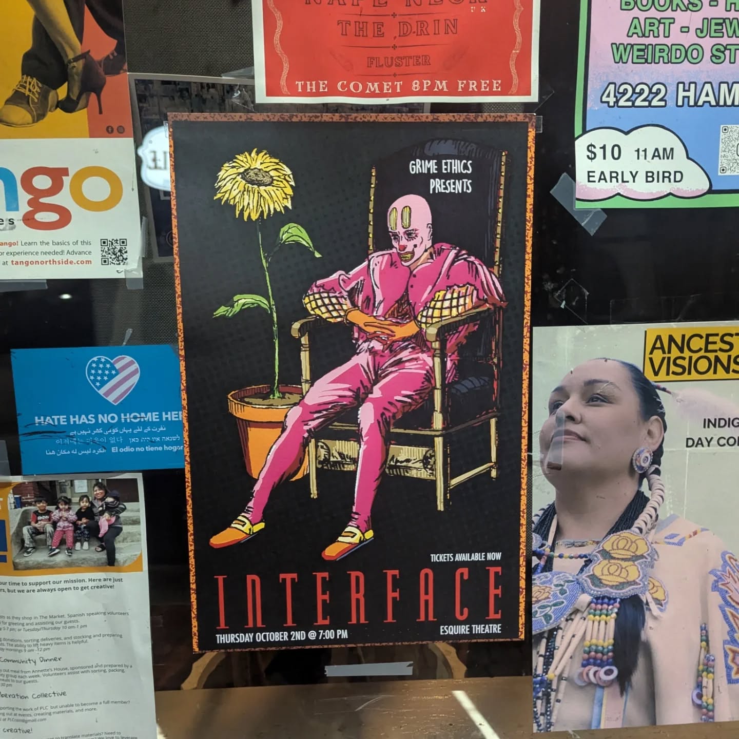 The Interface poster in a shop window beside other posters