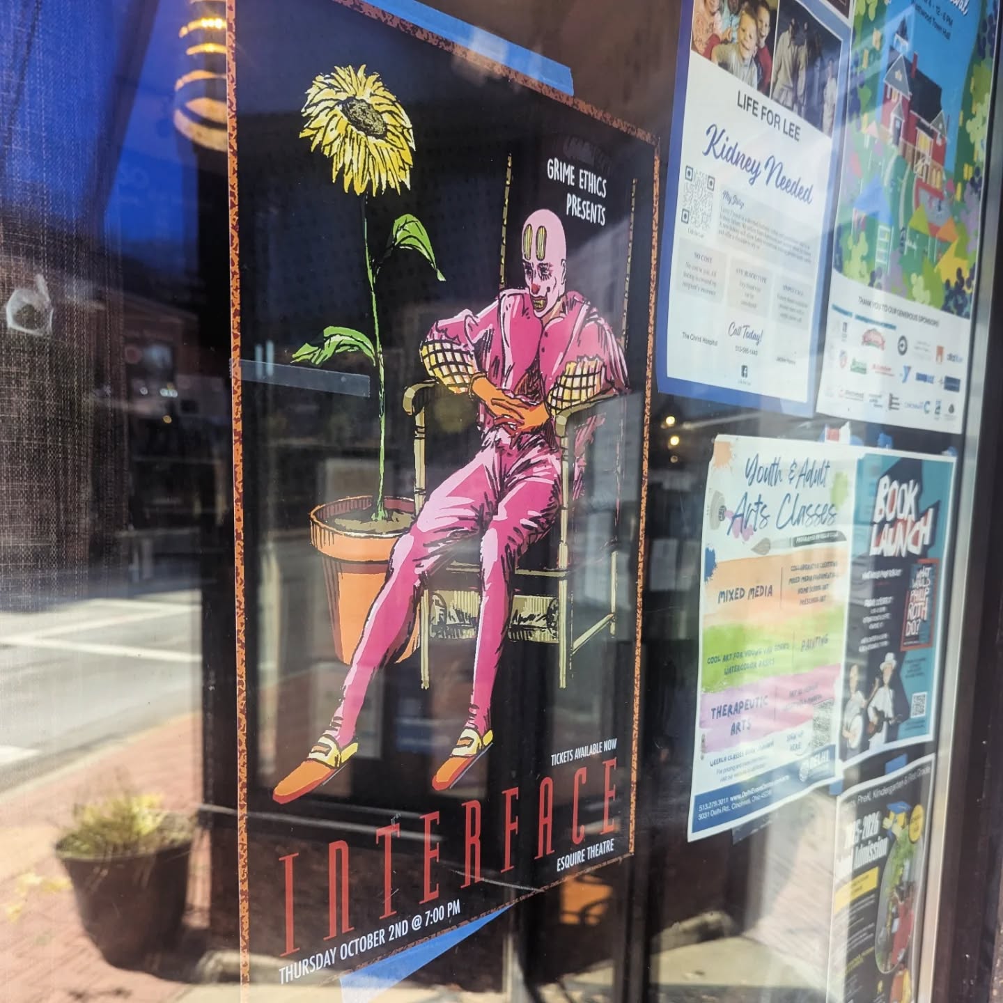 The Interface poster taped inside a shop window